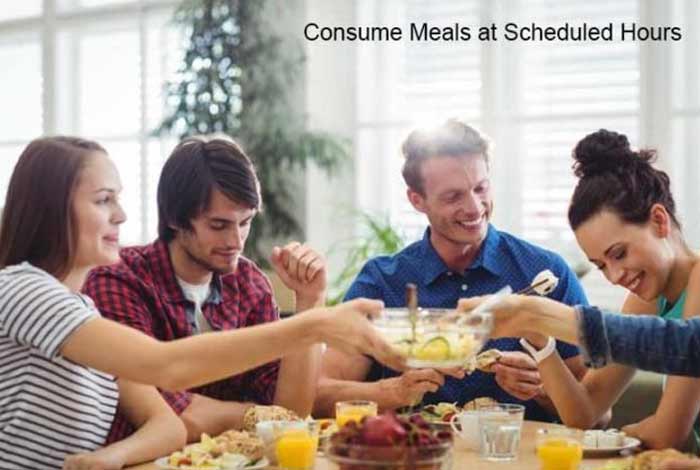 consume meals at scheduled hours